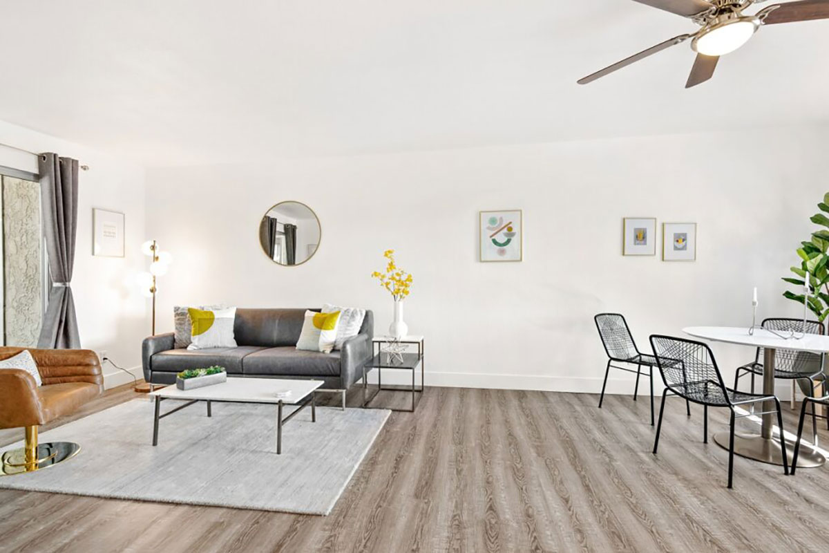 Furnished living and dining area with wood-style flooring.